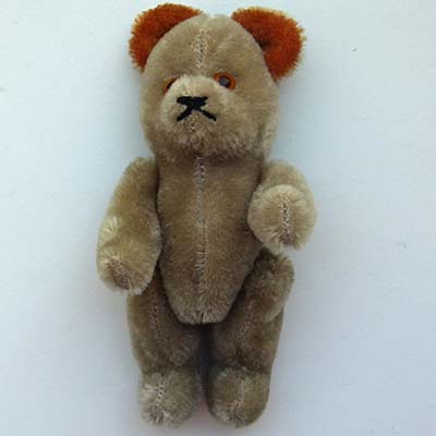 kleiner Teddybär, orange Ohren & Augen, alt